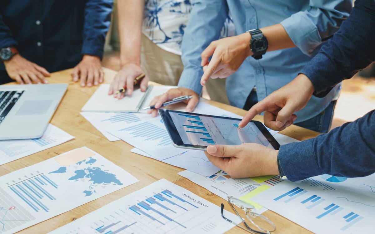 Business team analyzing growth charts and reports together in a strategy meeting